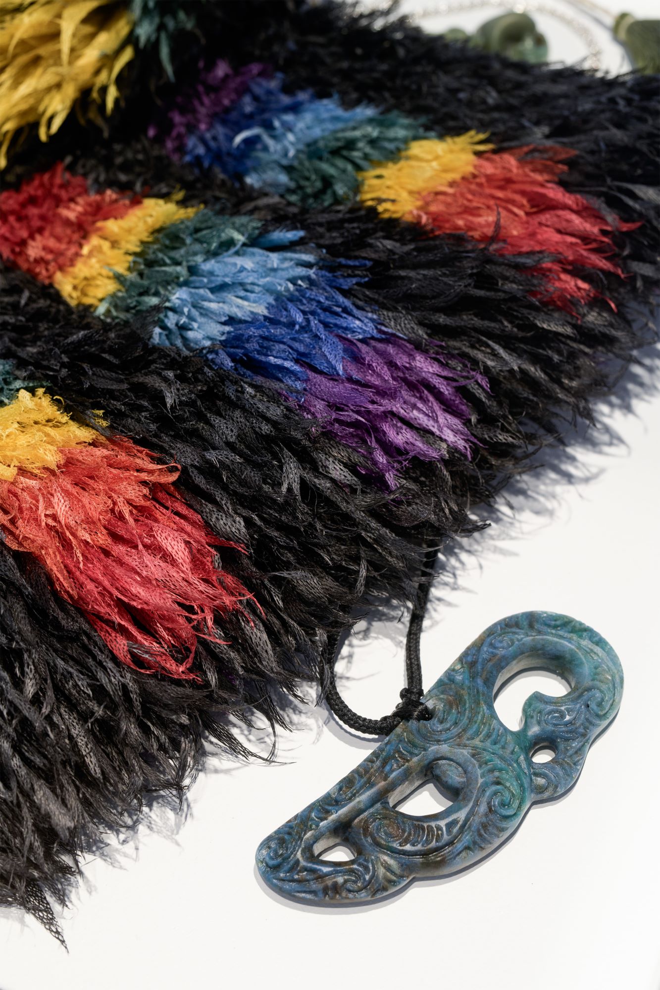 Isaac Te Awa - Kete houhi - detail, Houhi, muka, tae. Fayne Robinson - Manaia Aotea - detail, Aotea pounamu, taura iwituna. 'Āhuataka: A Wānaka of Kāi Tāhu Woven Adornment', Photo Credit Owen Spargo