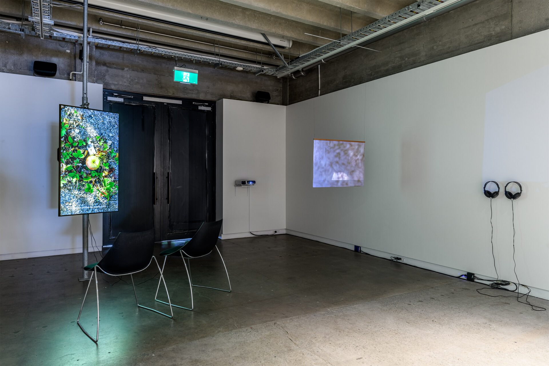 'There is (no) Anthropocene', Miranda Bellamy & Amanda Fauteux with Colleen Coco Collins, 'Unboxing Vid', 4K video, words and voice by Colleen Coco Collins, 7:27 minutes, 2025, Janine Randerson and Arielle Walker, 'Critical Minerals', Video projection and biocellulose screen, thread, recycled cedar. 680 x 880 mm, 5:34 minutes, 2025, Photo Credit Owen Spargo