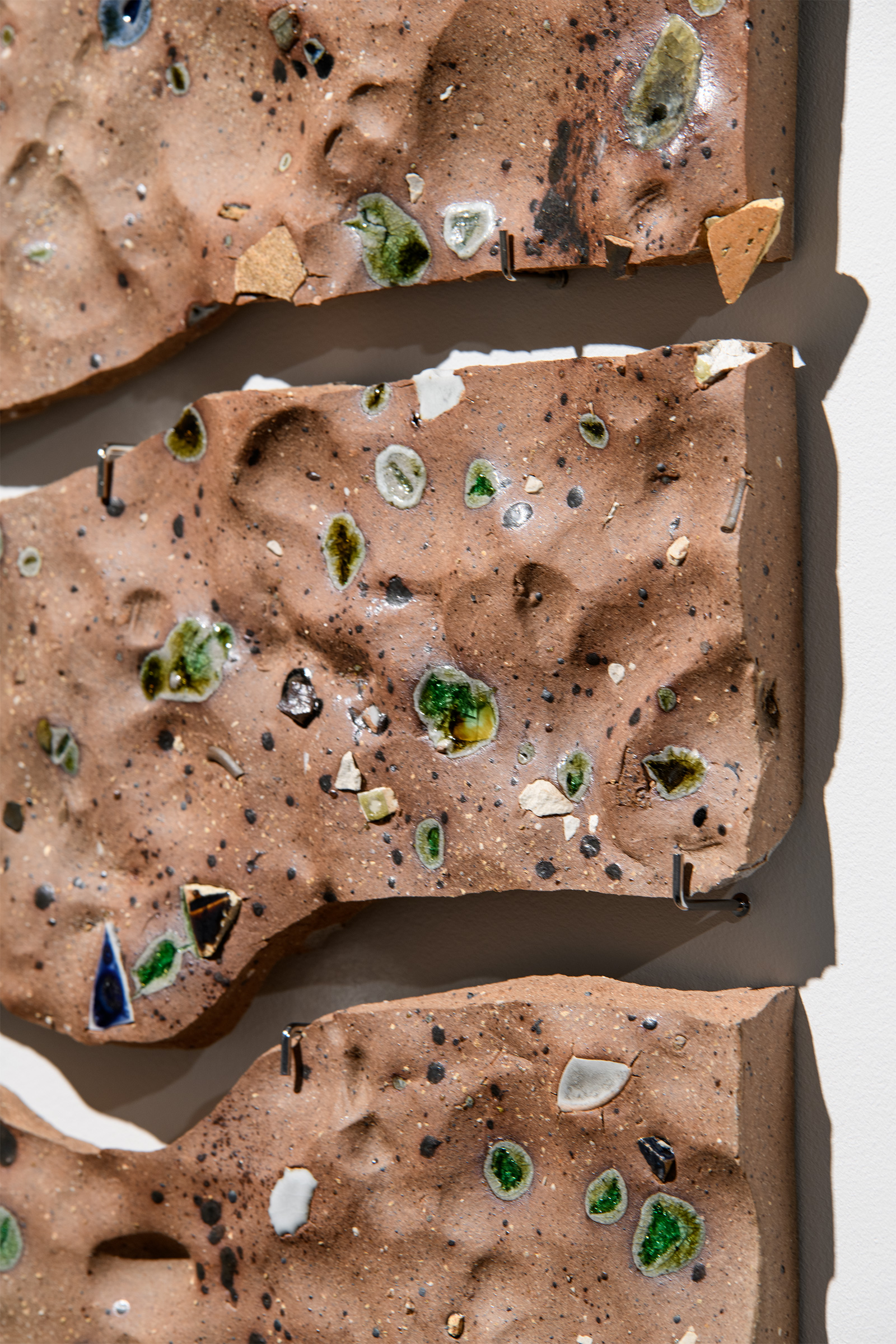 'Whakamenetia (to gather together) I' - detail, Reclaimed clay, found ceramic and glass from Whaka Oho Rahi, Basalt, Logan Park kōkōwai from Aroha, 275 x 460 mm 2026
