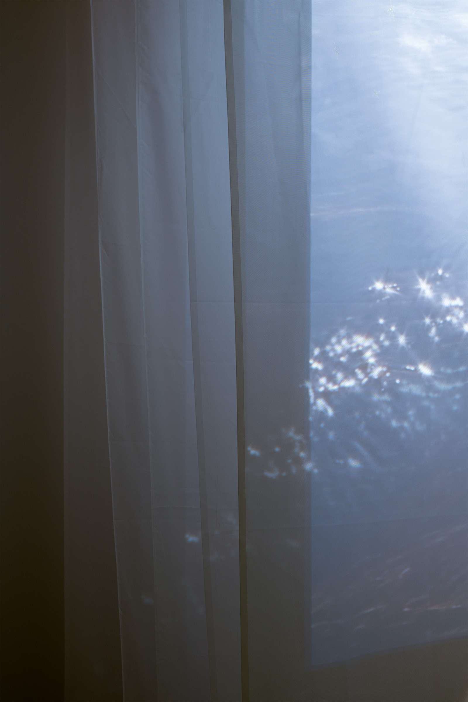 Ana Hislop (Kāi Tahu, Kāti Māmoe, Waitaha), 'Te Taha Wairua' - detail, Installation voile fabric, thread, kererū feathers, Single channel, digital video and sound, 16:59 minutes, 1053mm x 1500mm x 4000mm, 2024, photo credit Owen Spargo